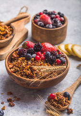 Morning  Granola, Fruits, Berries in bowl on grey concrete background. Healthy breakfast cereals. Concept of dieting, healthy  clean eating