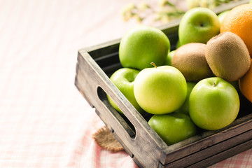 Fresh Green fruit in Wooden crate box. Diet and Healthy Concept.