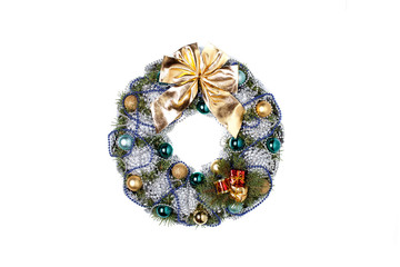 Christmas wreath with a golden bow and Christmas balls and balls of gray and blue color isolated on a white background.