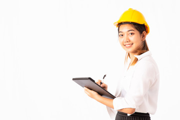 Smiling Asian engineer Woman with white shirt and yellow helmet writing report on clipping path, Isolated white background. Progress of the construction project concept.