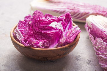 Purple chinese  napa cabbage on grey concrete table.  (leaf, head of cabbage and half).