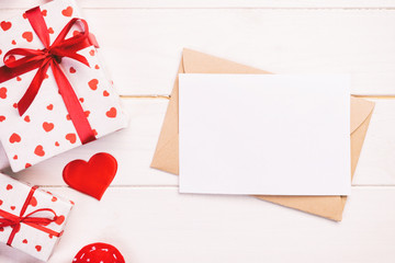 Envelope Mail with Red Heart and gift box over White Wooden Background. Valentine Day Card, Love or Wedding Greeting Concept