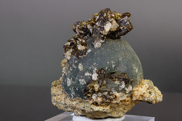 macro mineral stone Prehnite on Epidote on a gray background