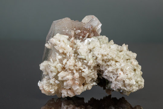 macro mineral stone Apophyllite stilbite on a gray background