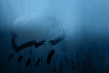 Cloud rain mark picture figure drawn with a finger on the classic blue color evening or morning...