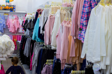 a pack of clothes on hangers on store shelves. Retail sales concept background.
