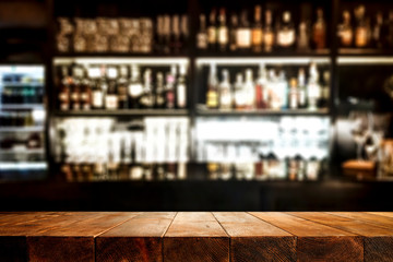 Glass of beer on wooden board and blurred bar background.Free space for your decoration. 