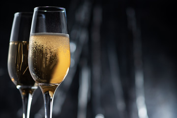 Glasses of champagne on the dark evening table . New year and Christmas celebrations