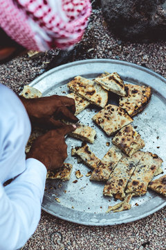 Bedouin Cutting Traditional Bread