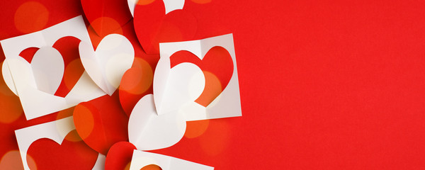 Paper craft hearts on a red background. Empty place for copy space for text. mock-up, minimal concept of romance winter february holiday. saint Valentine day, banner