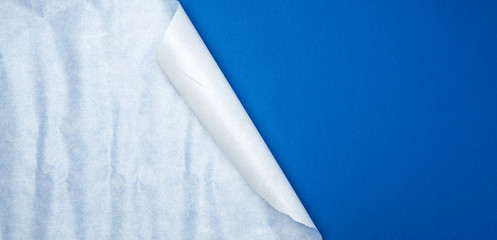 empty dark blue background with wrapped white sheet of paper