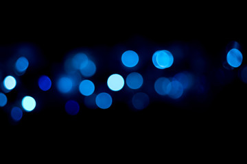 Christmas lights are always cheerful.  Out of focus lights gives an impression of light circles...