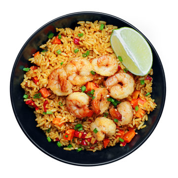 Fried Rice with fresh shrimp, rice, green onions, vegetables and lime in a bowl. Healthy Thai food isolated on white background. Top view, directly above shot with space for text.