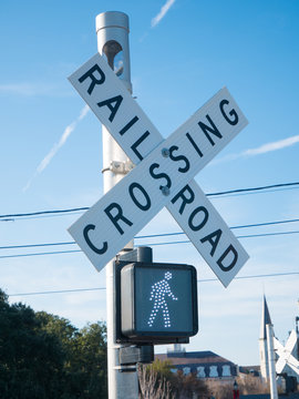 Pedestrian transit train crossing with warning lights.