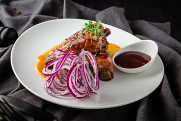 Baked Pork Ribs with BBQ Sauce. Restaurant menu. Background black boards.