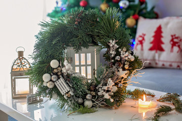 Fototapeta na wymiar Beautifully decorated advent wreath with white decoration on a table