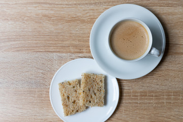 Coffee in white cup with Whole wheat bread on wooden background, Breakfast with healthy concept