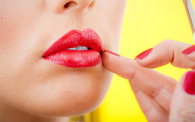 Professional lips make-up. Makeup professional artist applying lip gloss