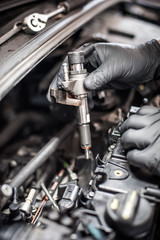 Fototapeta na wymiar Removing and changing valves. Car mechanic checking automobile valves