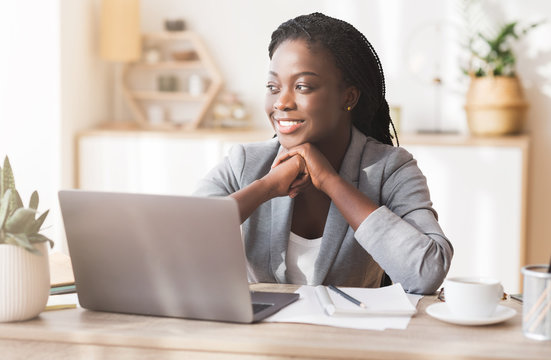 Portrait of successful black millennial female entrepreneur at workplace