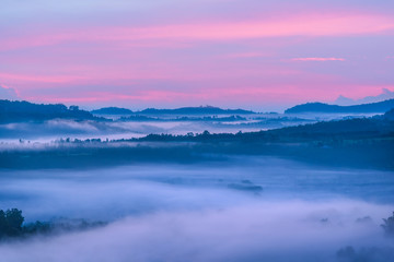 Amazing beautiful landscape view of mountains hill with fog dawn colourful sky in the morning.