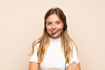 Young blonde woman over isolated background working with headset