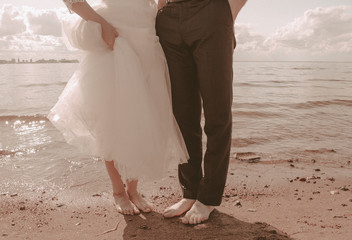 Fototapeta na wymiar bride and groom walking on beach
