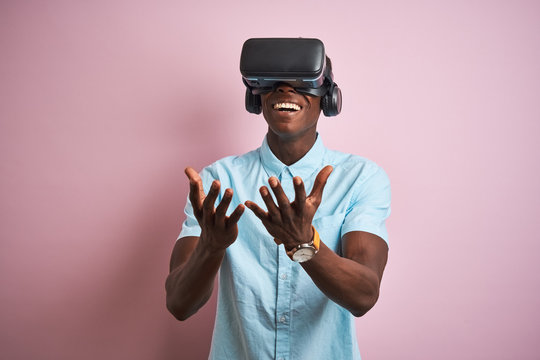 Young african american man playing virtual reality game using goggles