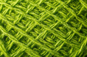 Wool yarn close up colorful green threads for needlework in macro.