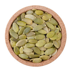 Pumpkin seeds on a plate on a white background