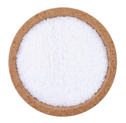 Coconut flakes on a plate on a white background