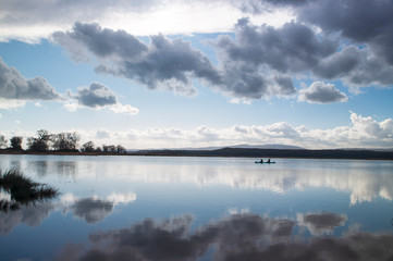 Canoe rowers on the lake with reflection, Igneada Turkey