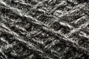 Wool yarn close-up gray threads for needlework in macro. Background texture fabric for knitting needle.