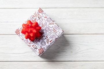 Holiday gift box on a white wooden background. with christmas decorations