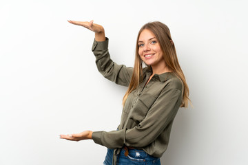 Lithuanian blonde girl over isolated white background holding copyspace to insert an ad