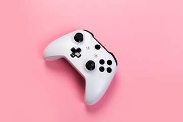 White joystick gamepad, game console on pink background. Computer gaming technology play competition videogame control confrontation concept. Cyberspace symbol © Nana_studio