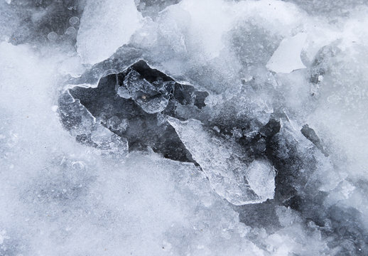 A Frozen Puddle With Broken Ice