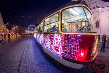 Christmas special tram illuminated by light with Christmas motif in Brno on traditional Moravian markets.