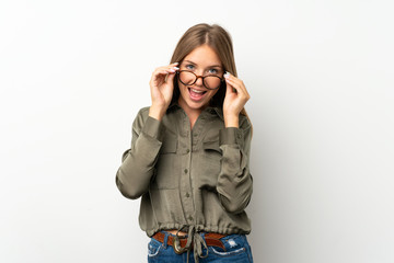 Lithuanian blonde girl over isolated white background with glasses and surprised