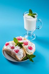 kefir is decorated with a leaf of mint, a fermented drink. Air cake on a saucer.
