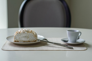A delicious roll of bezrukov and a cup of coffee on a table in a cozy coffee shop