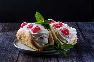 Airy raspberry cake in a plate on a wooden background