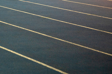 Fototapeta premium Gray treadmills in the stadium, close-up. Running tracks with marking. Stadium for professional athletes.