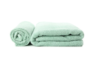 Folded fresh green towels isolated on white background