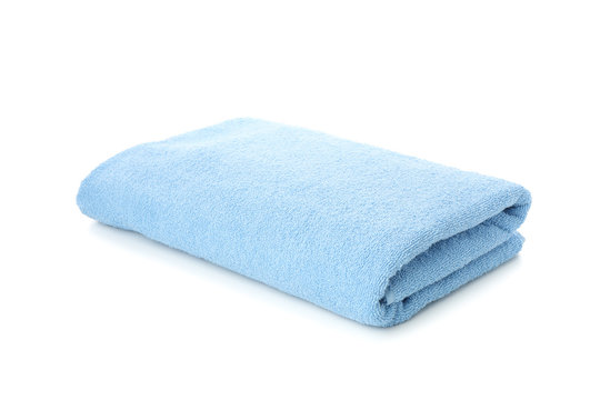Folded blue towel isolated on white background, close up