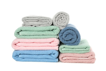 Fototapeta na wymiar Heap of folded color towels isolated on white background