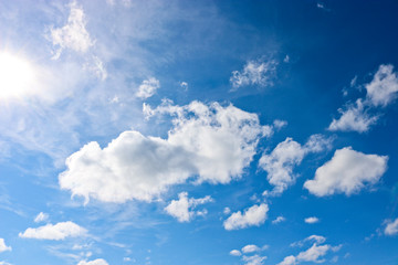 Sunny natural background, blue sky with cirrus and cumulus clouds. The concept of travel, dreams, vacation, summer mood.