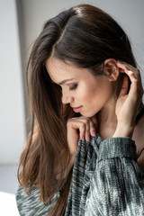 Close-up beautiful tender woman posing near window