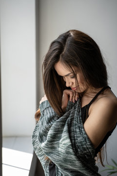 Portrait Of Beautiful Woman With Gray Cardigan Near Bright Window