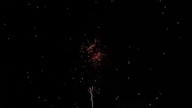 Fireworks in sky on black background with copy space
